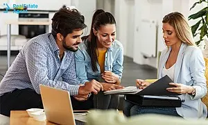 Real estate agent selling house to young couple